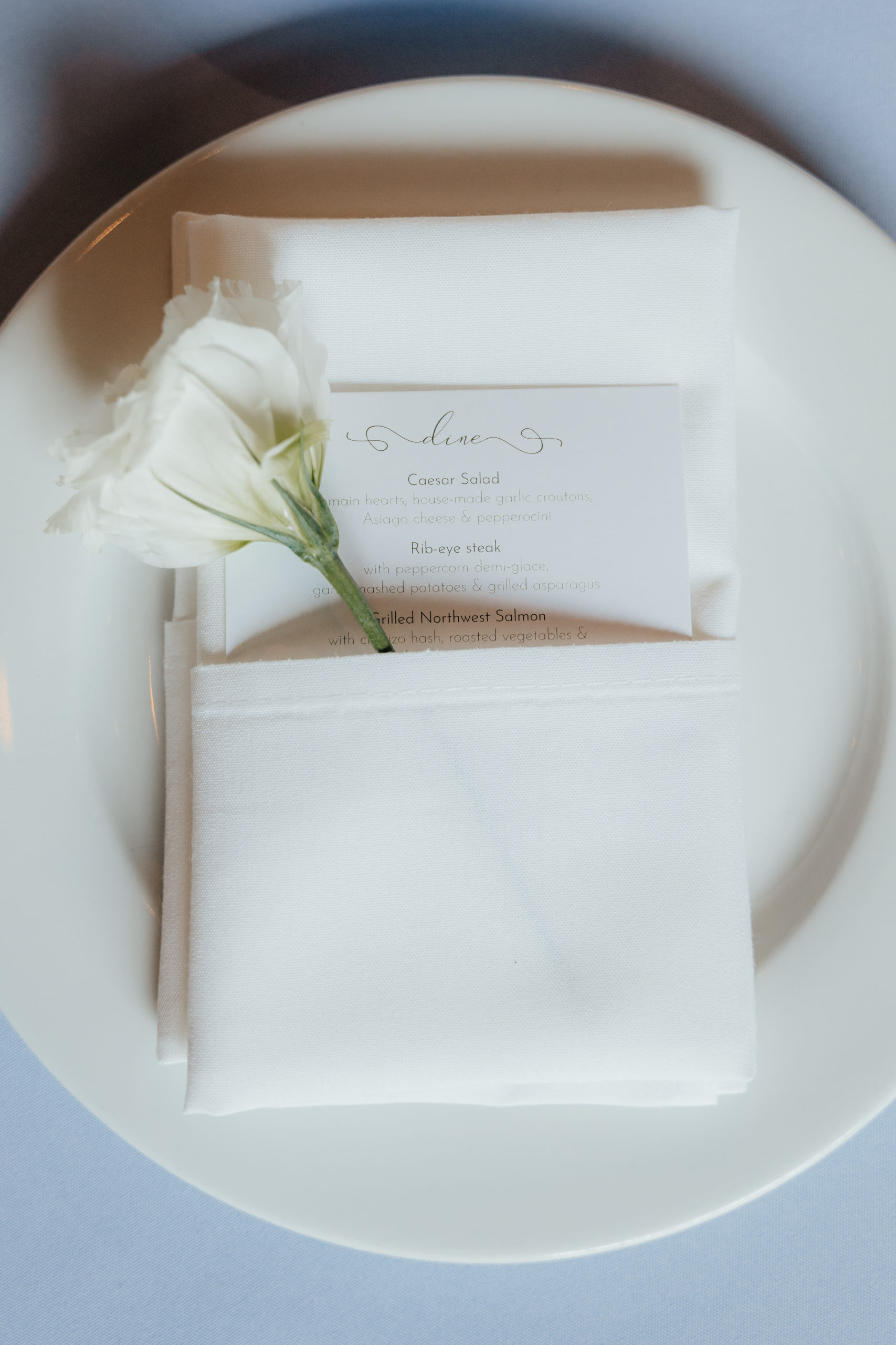 Wildflower wedding details on each guest's plate.